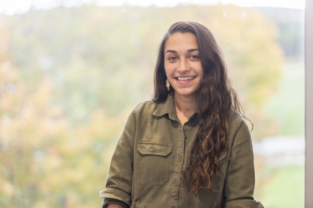 Student in the Bull and Bear Lounge outside of the Bath Iron Works Business Simulation Lab in the Tower on the Central Maine Community College campus