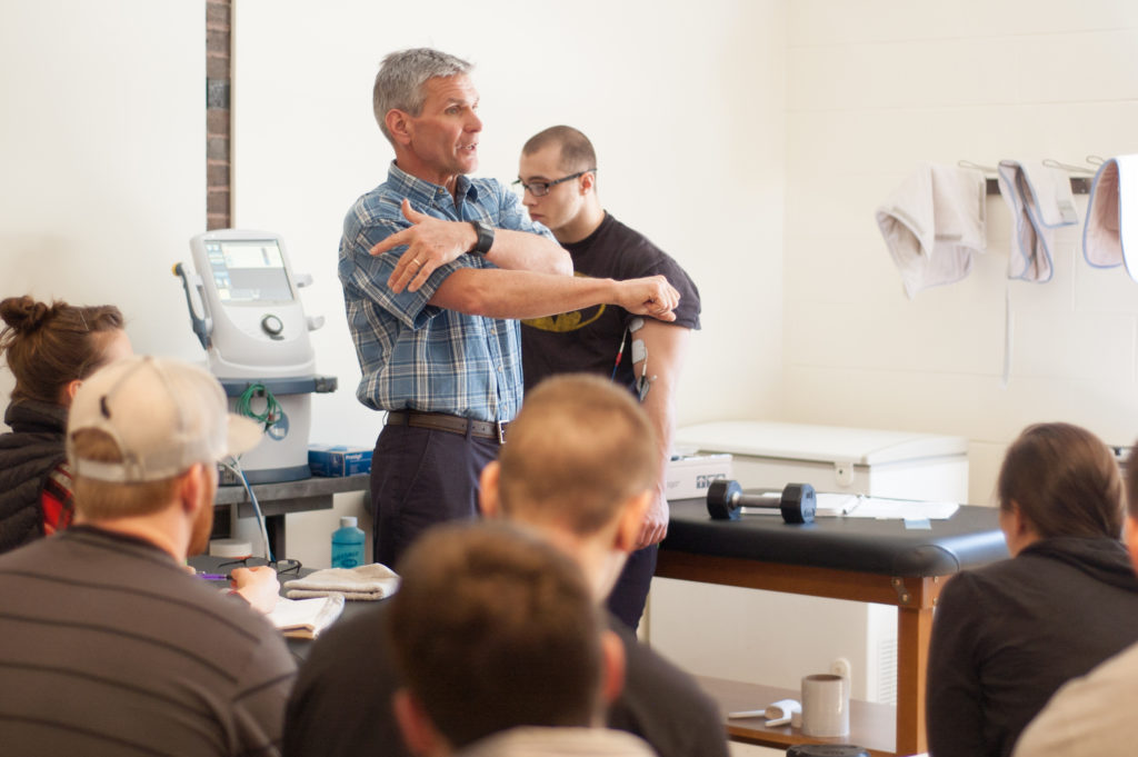 Bob Brainerd, owner of Central Maine Conditioning Clinic, discusses proper analysis and training with students as part of the Physical Fitness Specialist program at Central Maine Community College.