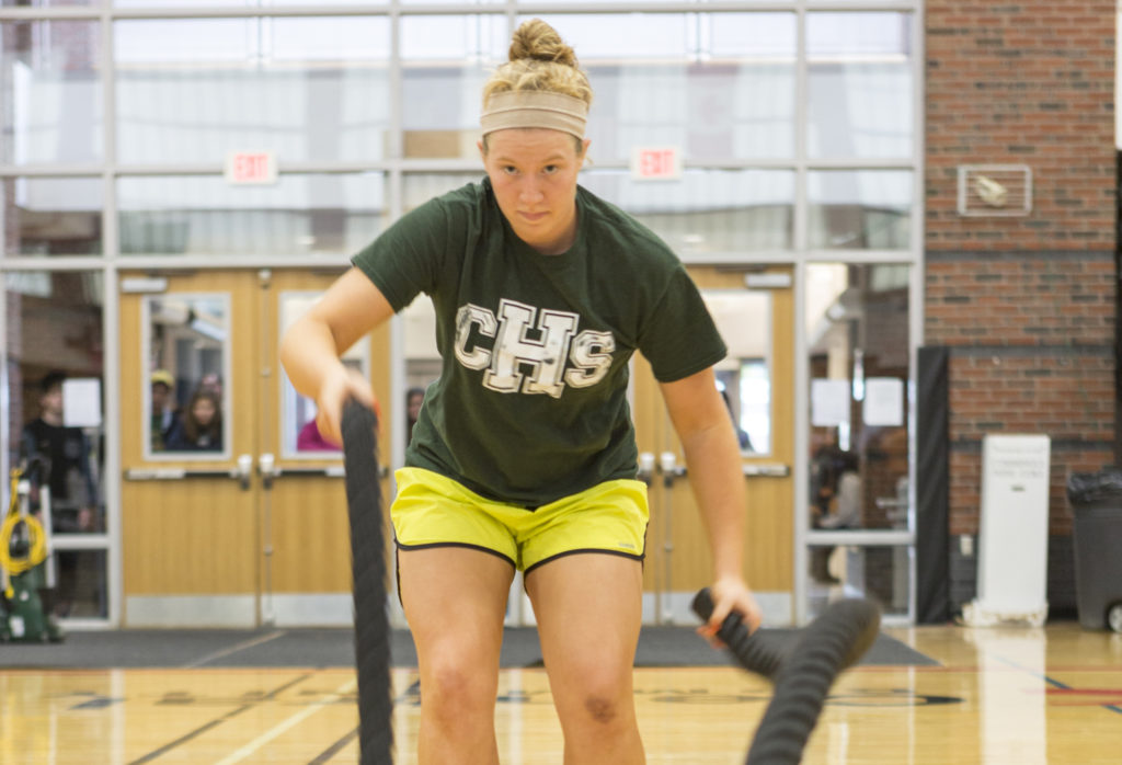 A female student participates in a workout and learns about battle ropes during a course for the Physical Fitness Specialist program at Central Maine Community College.
