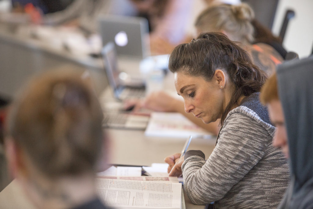A female participates in a lecture hall at Central Maine Community College