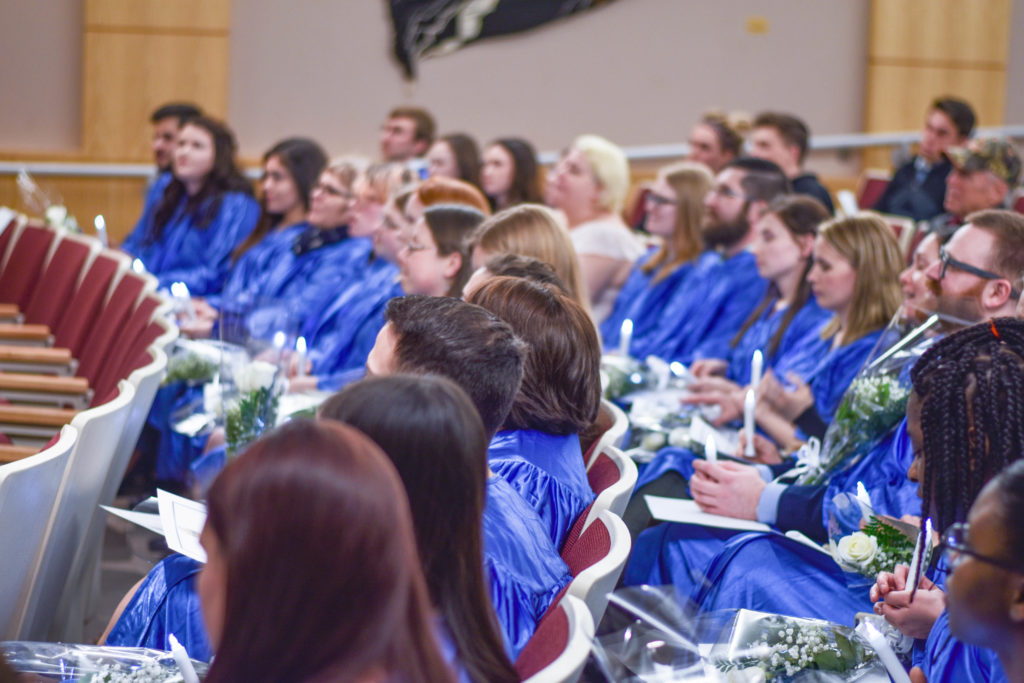 A large group of students in blue robes participate in the Phi Theta Kappa Honors Society spring 2017 Induction. These individuals have achieved high academic goals.