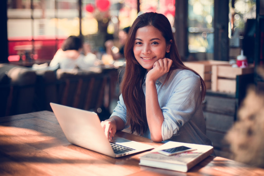 Woman on laptop in a cafe.