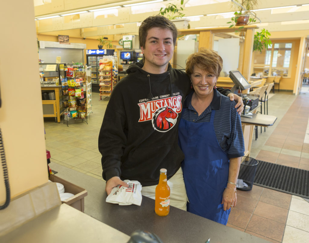 A male student poses with a female staff member of the dining commons. Many students create close relationships with staff members here!