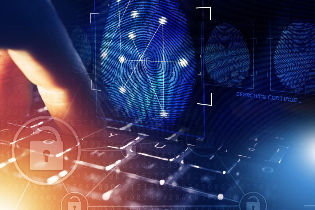 Creative image of individual pressing a computer keyboard button with an overlay of a security lock