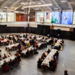 Large event in Kirk Hall gymnasium with large screen presentation