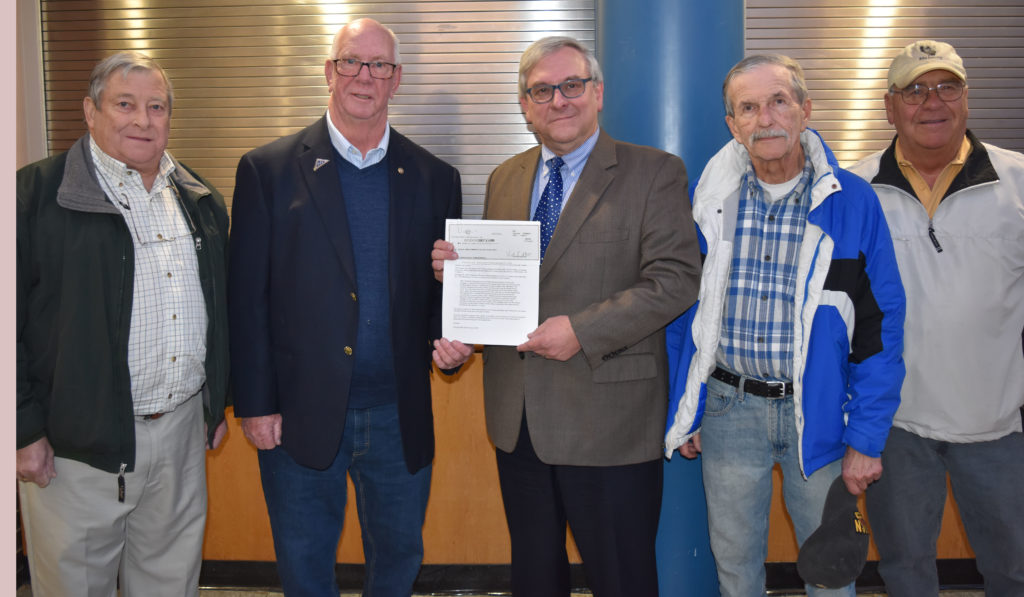 Mike McMahon second from left, presents a check to Roger Philippon, dean of planning and public affairs at CMCC, to fund scholarships at the college in memory of his brother Thomas. Others left to right are members of the LHS Class of 1967 who raised the funds for the scholarships: Ron Paradis, Paul Labbe, and Paul Lavoie. 