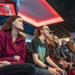 Shawna Chretien, left, watches Mallory Mercier play a video game at Central Maine Community Center’s Esports open house Saturday morning. Mercier is a CMCC student and is considering switching her major from liberal studies to esports management. Next to Mercier are Connor Beaulieu and Mercier’s twin sister, Megan.