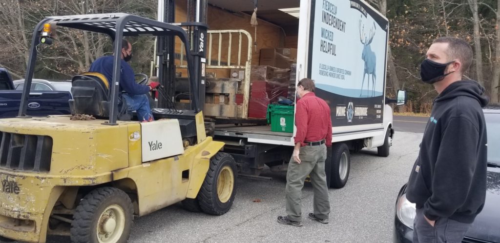 Truck filled wtih donations from Maine Hardware with masked students and instructors. 